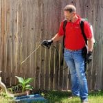 Emtec Pest Control in Tulsa - Exterminator spraying yard