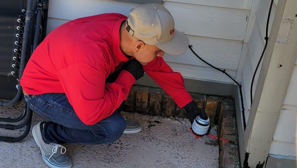 Emtec Pest Control Tulsa Technician Inspecting for Pests