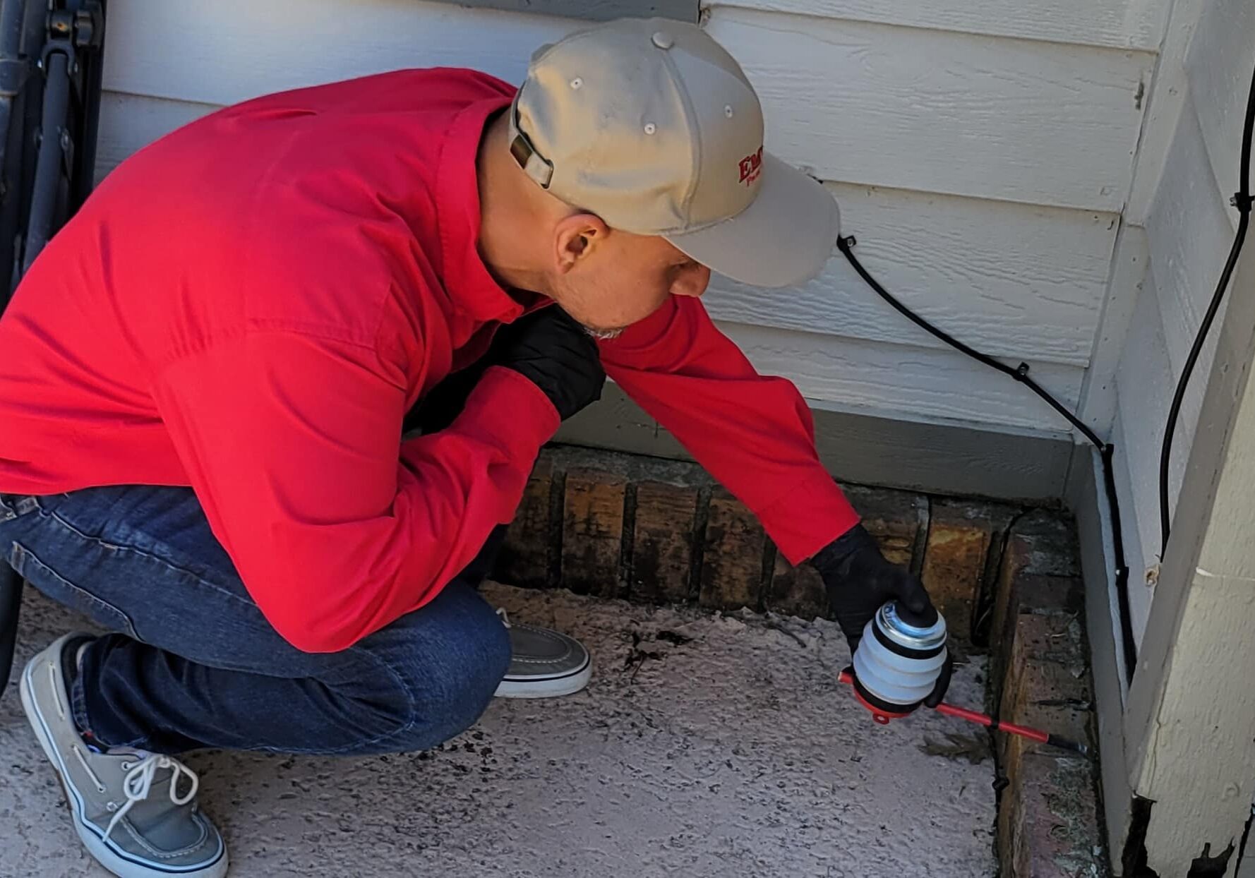 Emtec Pest Control Tulsa Technician Inspecting for Pests