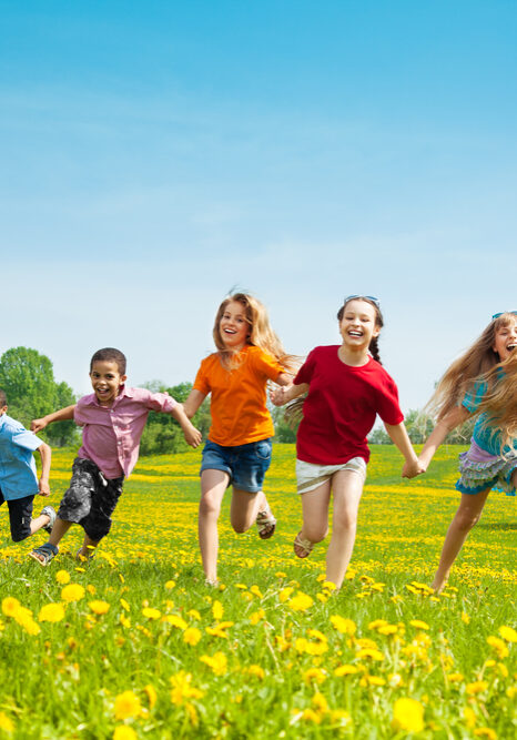 Group of seven kids running in the park