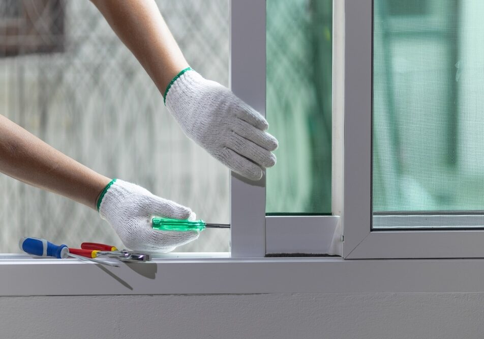 Construction worker repairing the sliding window