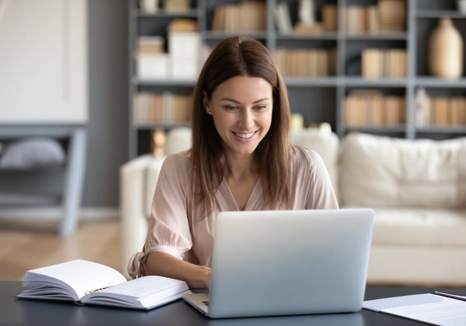 Head shot young happy woman sitting at desk